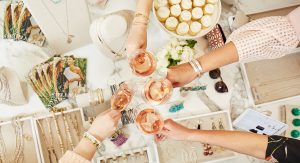 Guests enjoying a toast with wine glasses and jewelry in the picture